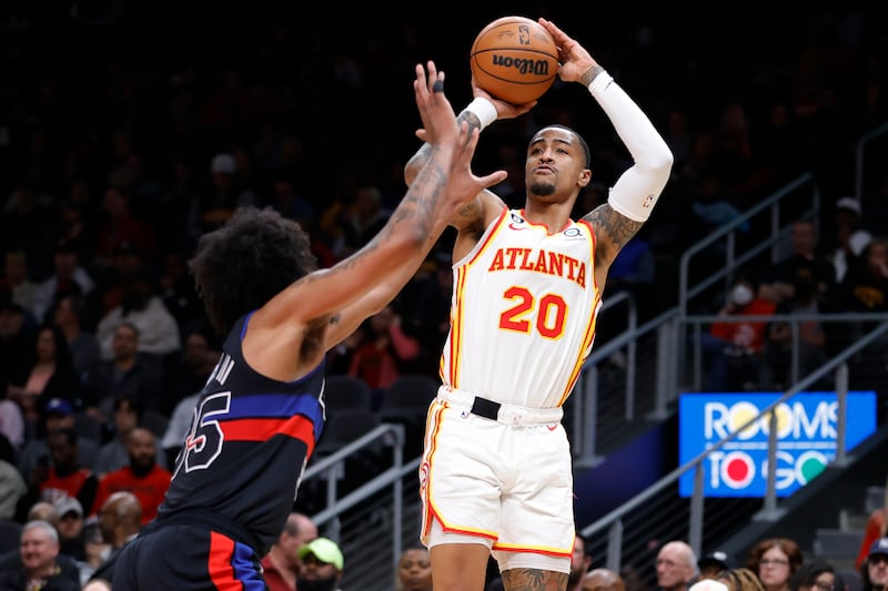 Atlanta Hawks forward John Collins shoots over Detroit Pistons forward Marvin Bagley III,