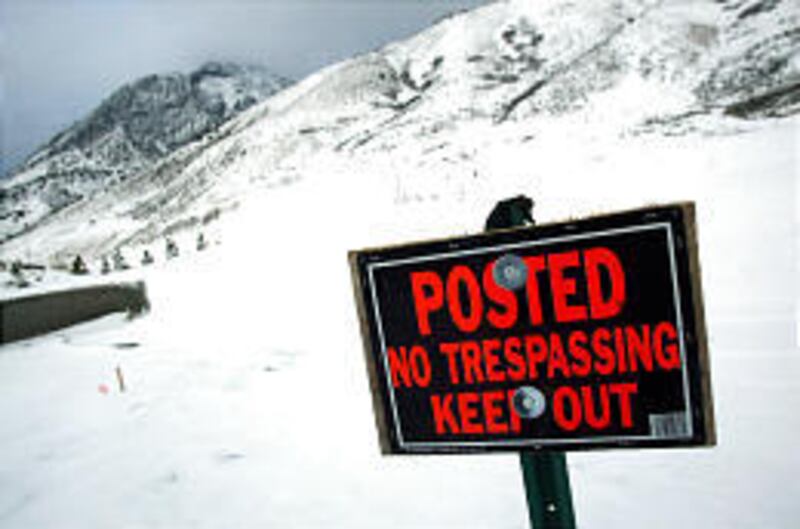 Despite no-trespassing signs, people go sledding on Cedar Hills course.