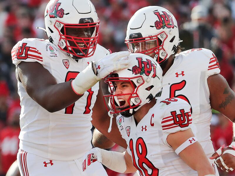 Utah wide receiver Britain Covey (18) is congratulated after scoring against Ohio State in the 108th Rose Bowl.