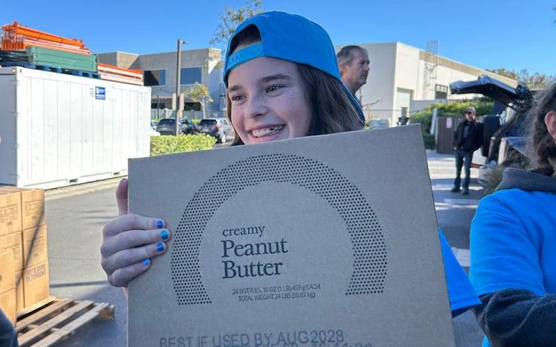 Lacey Smith, a JustServe youth volunteer, helps move boxes from an America250 food donation from The Church of Jesus Christ of Latter-day Saints onto pallets for delivery to almost a dozen different charities in the Irvine, California, area on Saturday, Feb. 21, 2026.