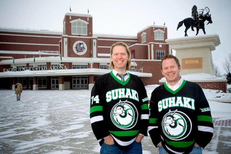 In this Jan. 14, 2011 photo, Steve Ekman, left, and Hans Halvorson, both of Grafton, N.D., pose with their Suhaki jerseys outside of the Ralph Engelstad Arena in Grand Forks, N.D., where the University of North Dakota Fighting Sioux hockey team plays. The