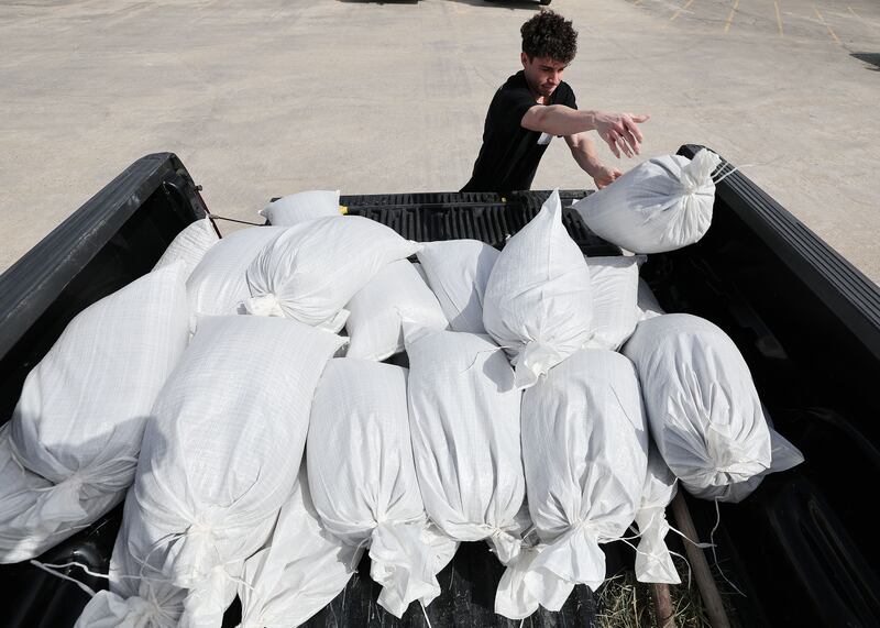 Mike McComb loads sand bags in his truck at the Salt Lake County Public Works Operations Division in Midvale on March 29, 2023.