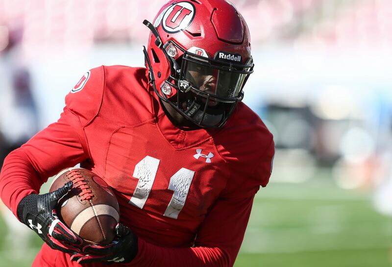 Malone Mataele (11) runs the ball during the University of Utah scrimmage at Rice-Eccles Stadium.