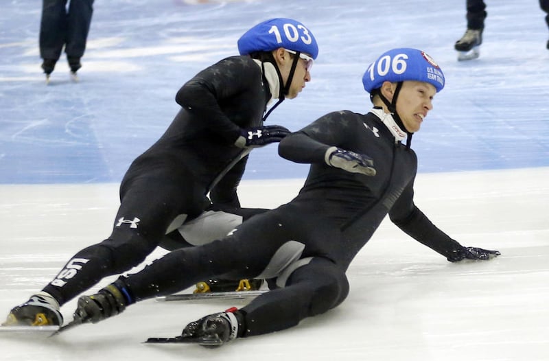 Keith Carroll Jr. (106) and Ryan Pivirotto (103) crash in the men's 1000-meters A final race during the U.S. Olympic short track speedskating trials Sunday, Dec. 17, 2017, in Kearns, Utah. (AP Photo/Rick Bowmer)