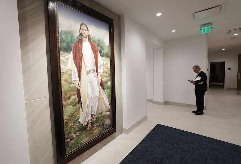 Matt Baldwin, director of real estate development for City Creek, walks past a painting as news media tour two new urban chapels of The Church of Jesus Christ of Latter-day Saints,