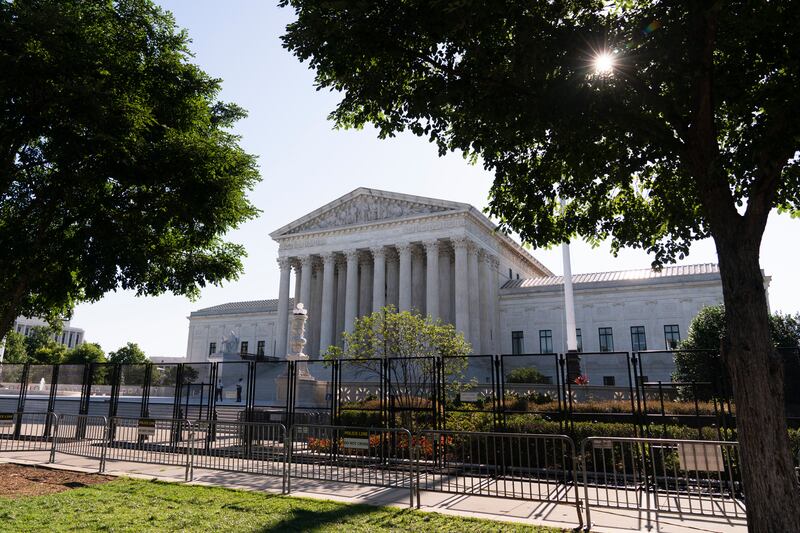 The U.S. Supreme Court building with two trees bordering the photo.