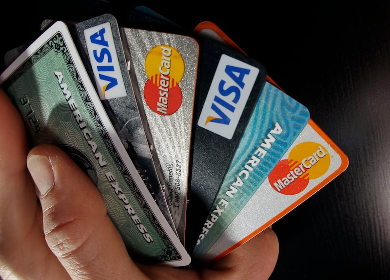 In this March 5, 2012 file photo, consumer credit cards are posed in North Andover, Mass. Children can be victims of identity theft and it often goes unnoticed by parents for years. Experts say more parents should actively monitor their child’s credit to