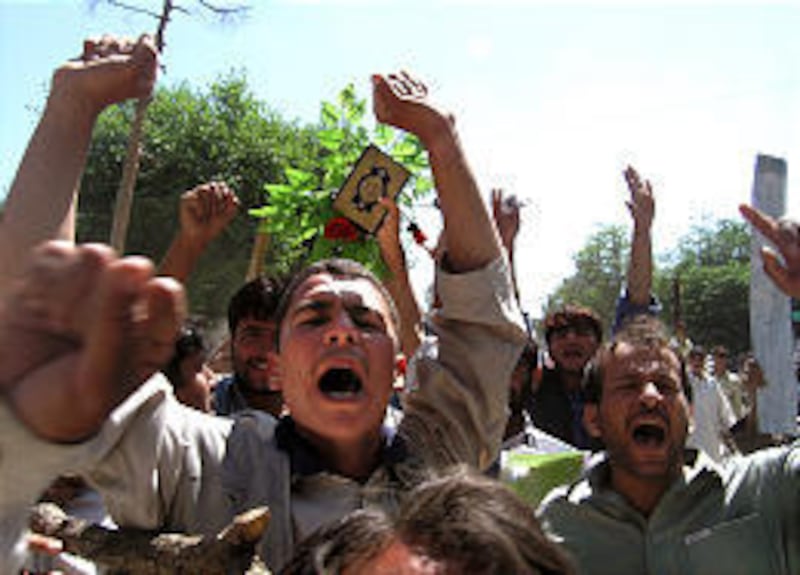 Afghan university students march in the streets in Jalalabad, Afghanistan, carrying copies of the Quran.