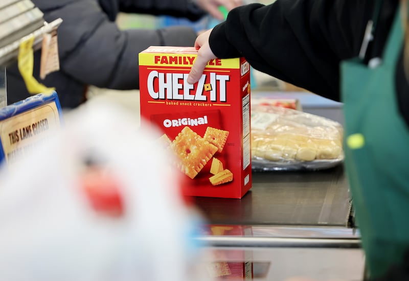 Employee Natasha Borgersen scans a box of Cheez-It crackers at Reams in Sandy, Utah.