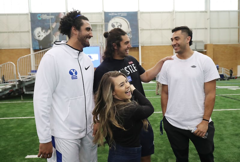 Brigham Young Cougars players and brothers Corbin Kaufusi, Bronson Kaufusi and Devin Kaufusi laugh while being interviewed during Pro Day in Provo on Friday, March 29, 2019.