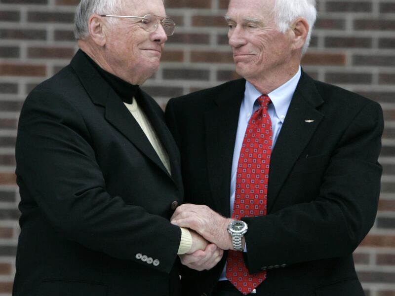 FILE - In a Oct. 27, 2007 file photo, former astronaut Neil Armstrong, left, is congratulated by fellow ex-astronaut Gene Cernan following the dedication ceremony of the Neil Armstrong Hall of Engineering at Purdue University in West Lafayette, Ind. NASA