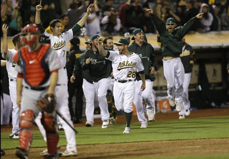 The Oakland Athletics celebrate a game- winning two-run home run by Brandon Moss during the nineteenth inning of a baseball game against the Los Angeles Angels on Tuesday, April 30, 2013 in Oakland. Calif. Oakland won 10-8 in 19 innings.