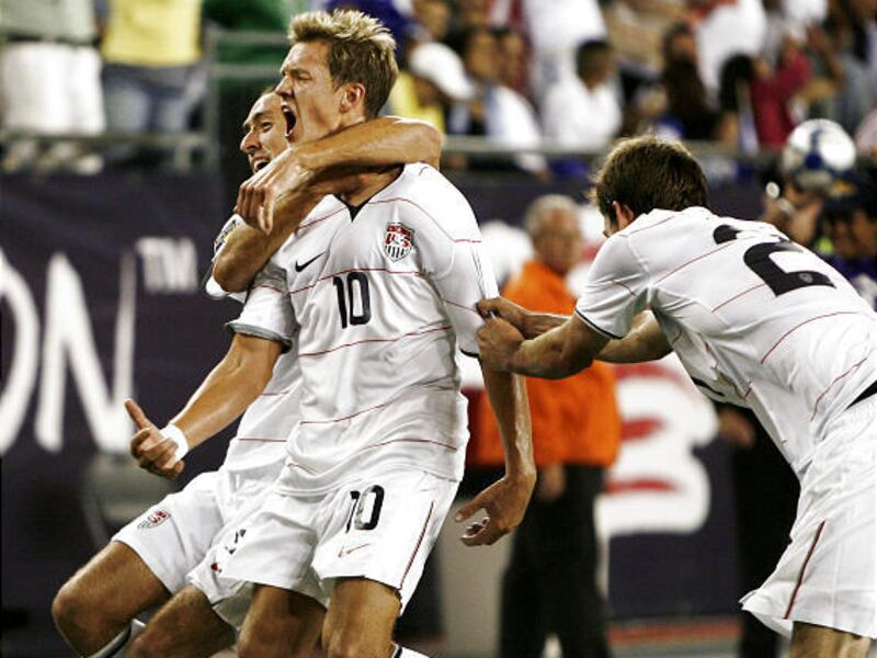 United States' Stuart Holden, 10, is congratulated by teammates Davy Arnaud and Brad Evans, right, after Holden scored during extra time of the second half to tie Haiti 2-2 in a CONCACAF Gold Cup soccer match at Gillette Stadium in Foxborough, Mass., Satu