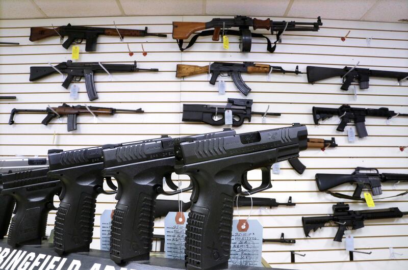 Assault weapons and handguns are seen for sale at Capitol City Arms Supply in 2013 in Springfield, Ill.