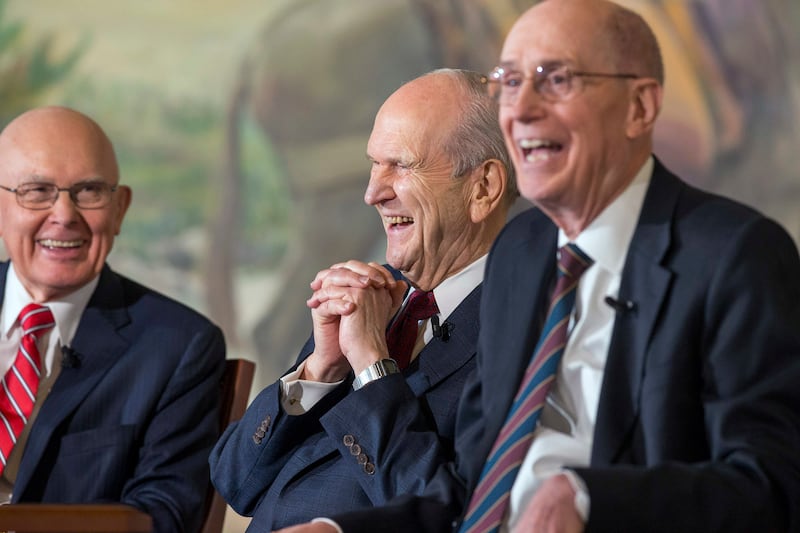 President Russell M. Nelson, the 17th president of The Church of Jesus Christ of Latter-day Saints, and his counselors — President Dallin H. Oaks, first counselor (left), and President Henry B. Eyring, second counselor (right) — share in a laugh at a pres