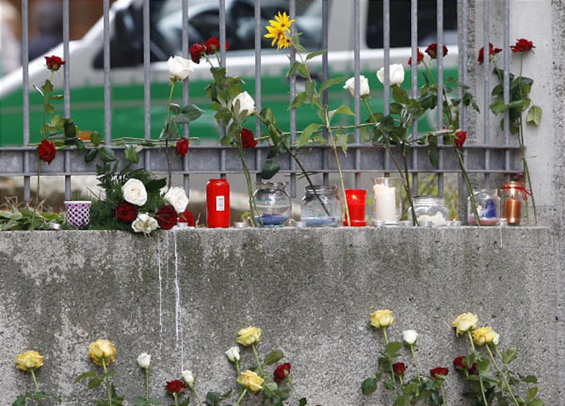 Flowers and candles are seen in front of the Carolinum school in Ansbach, Germany, on Friday.