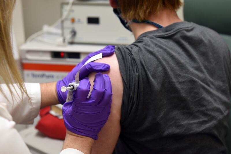 In this May 4, 2020 photo provided by the University of Maryland School of Medicine, the first patient enrolled in Pfizer’s COVID-19 coronavirus vaccine clinical trial at the University of Maryland School of Medicine in Baltimore, receives an injection.