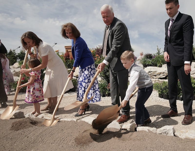 Elder Brook P. Hales and his grandson, Clark, shovel dirt during the Deseret Peak Utah Temple groundbreaking on May 15, 2021.