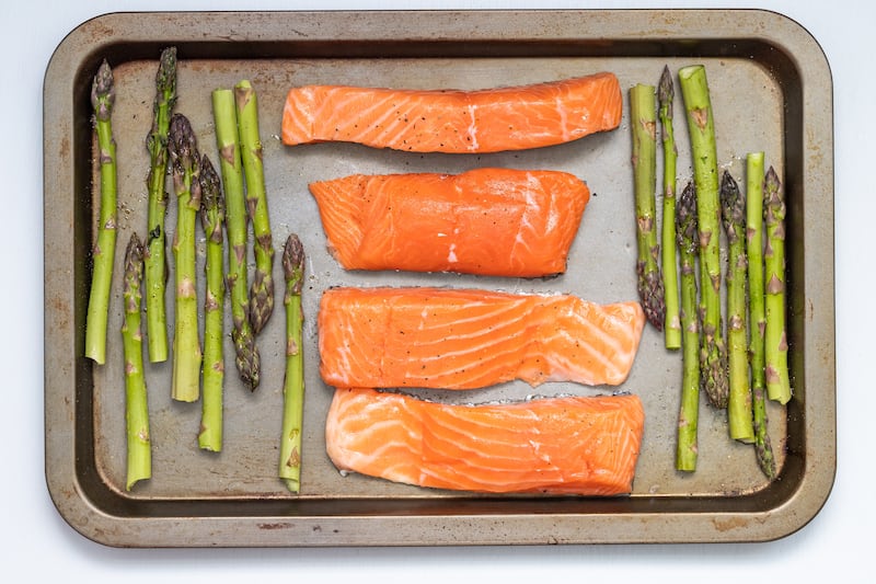 A photograph of salmon with asparagus.