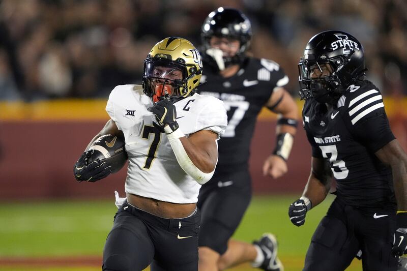 Central Florida running back RJ Harvey runs the ball as Iowa State defensive back Jontez Williams gives chase Saturday, Oct. 19, 2024, in Ames, Iowa. No. 11 BYU travels to Orlando Saturday to put its undefeated season on the line vs. the Knights.