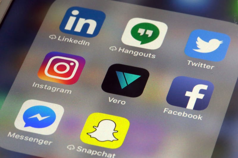 The Vero app, center, is displayed on an iPhone in New York, Thursday, March 1, 2018. Instagram users fed up with ads, with the end of chronologically displayed posts and the lack of granular privacy controls are flocking to Vero app.