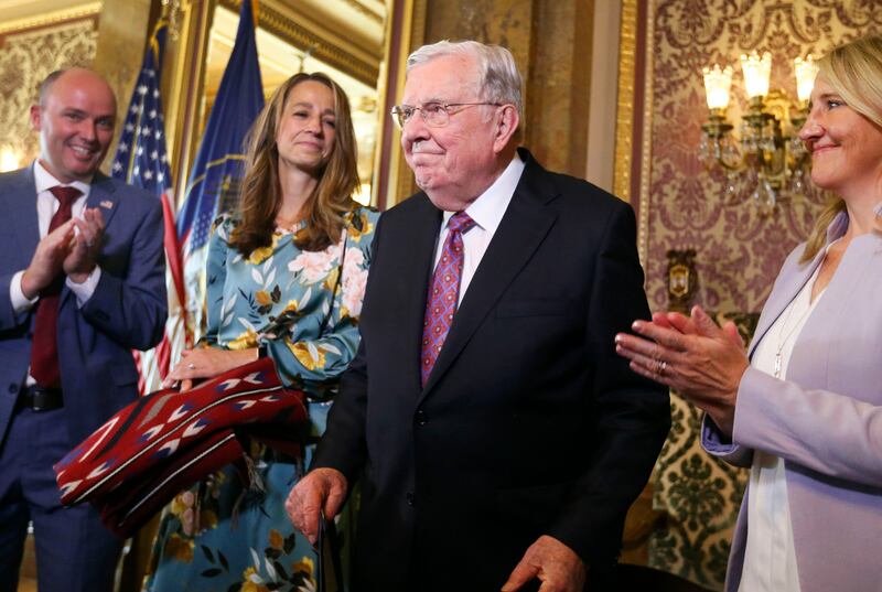 Gov. Spencer Cox, first lady Abby Cox and state Rep. Melissa Garff-Ballard applaud as President M. Russell Ballard is recognized during a ceremony at the Capitol in Salt Lake City.