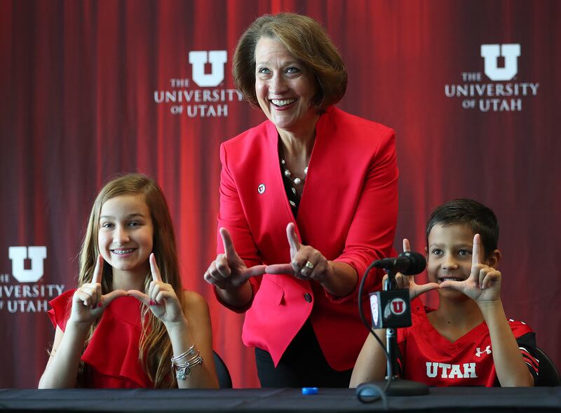 University of Utah President Ruth Watkins and Savanah and Austin Harlan get their "U" up after a press conference at Rice-Eccles Stadium on Monday, June 4, 2018.