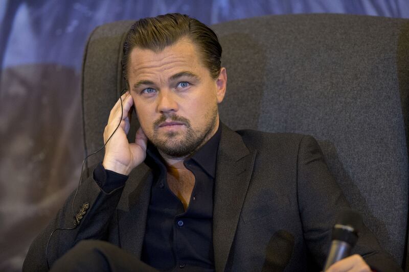 Actor Leonardo DiCaprio listens to a question over a translation earpiece during a press event to promote his new film "The Revenant," in Mexico City, Tuesday, Jan. 26, 2016.