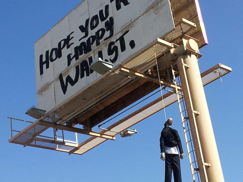 This image provided by KVVU-TV shows a billboard with a mannequin dangling from a hangman's noose near The Strip in Las Vegas. Authorities said calls began coming in early Wednesday Aug. 8, 2012, from drivers worried the dummy along Interstate 15 near was