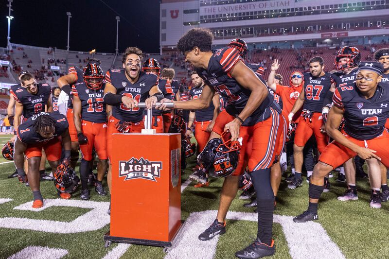 The Utah Utes celebrate on the field by “Lighting The U”, after beating the San Diego State Aztecs in Salt Lake City on Saturday, Sept. 17, 2022. The Utes won 35-7.