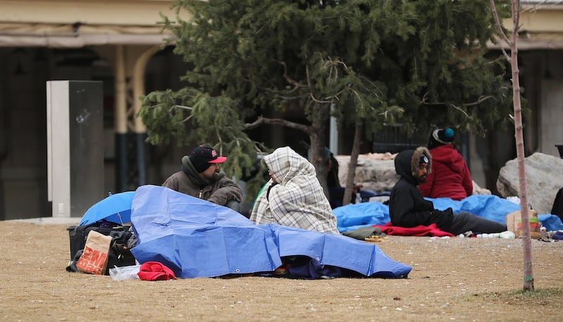 FILE - Homeless persons bundle up in downtown Salt Lake City on Thursday, Dec. 8, 2016. The First Presidency of the LDS Church authorized the release of a statement Thursday afternoon about the faith's response to homelessness generally and the situation