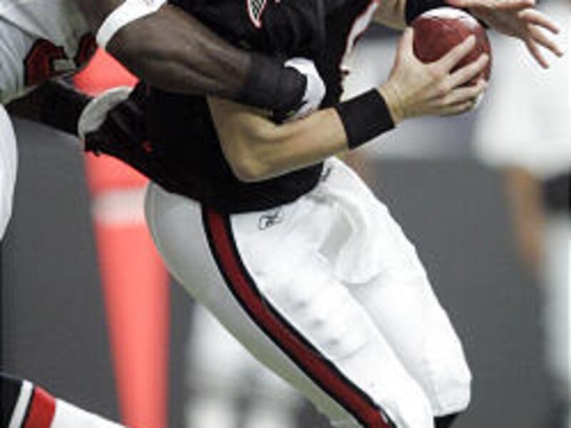 Atlanta Falcons quarterback Chris Redman (8) is sacked by Tampa Bay Buccaneers defensive end Stylez White (91) during the second quarter of an NFL football game in Atlanta on Sunday.