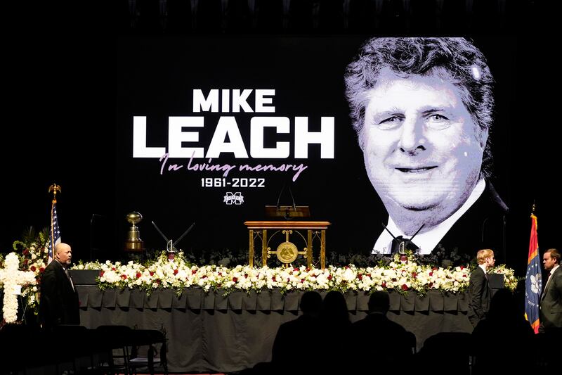 School officials gatherprior to the start of a memorial service for Mike Leach, in Starkville, Miss., Tuesday, Dec. 20, 2022.