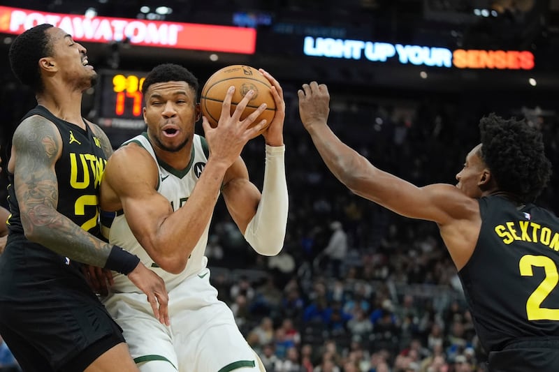 Milwaukee Bucks’ Giannis Antetokounmpo drives between Utah Jazz’s Lauri Markkanen and Collin Sexton during the first half of an NBA basketball game Monday, Jan. 8, 2024, in Milwaukee. (AP Photo/Morry Gash)