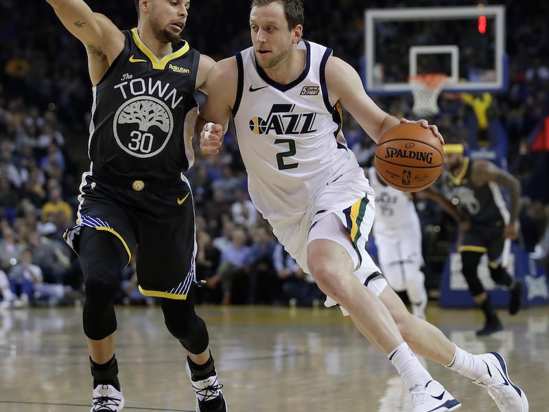 Utah Jazz forward Joe Ingles, right, drives the ball against Golden State Warriors' Stephen Curry (30) during the first half of an NBA basketball game, Tuesday, Feb. 12, 2019, in Oakland, Calif. (AP Photo/Ben Margot)