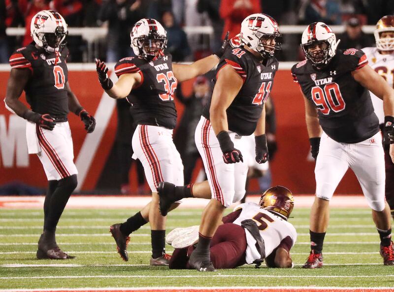 Utah Utes defensive tackle Hauati Pututau celebrates