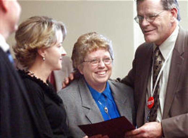 Heidi Monson, left, 2005 Utah Mother With Young Children of the Year, and Jeanne Jennings Godfrey, 2005 Utah Mother of the Year, join state Sen. Scott Jenkins, R-Plain City, after receiving their awards at the Utah State Capitol in a Friday ceremony.