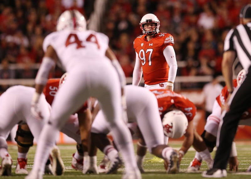 Utah Utes placekicker Matt Gay, wearing red, lines up a field goal.