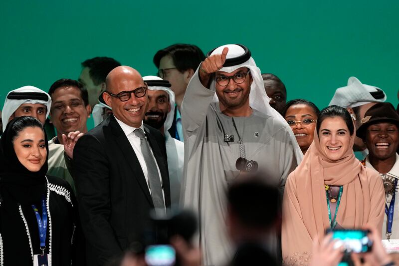 United Nations Climate Chief Simon Stiell, left, and COP28 President Sultan al-Jaber pose for photos at the end of the COP28 U.N. Climate Summit, Wednesday, Dec. 13, 2023, in Dubai, United Arab Emirates.