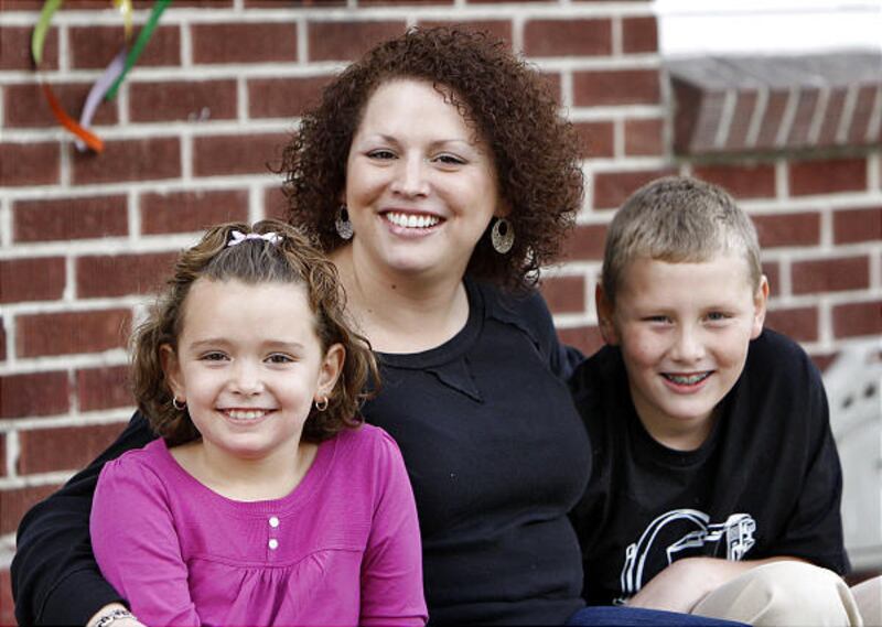Romina Artaza, who is a Single Moms Foundation scholarship recipient, sits with her children, Brindi and Andrew.