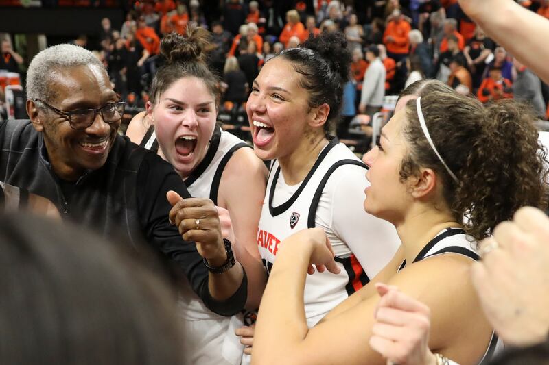Oregon State’s Raegan Beers, Timea Gardiner, and Talia von Oelhoffen, from left, celebrate the team’s 68-62 win over Colorado with team director of player personnel Eric Ely, left, following an NCAA college basketball game Friday, Jan. 26, 2024, in Corvallis, Ore.