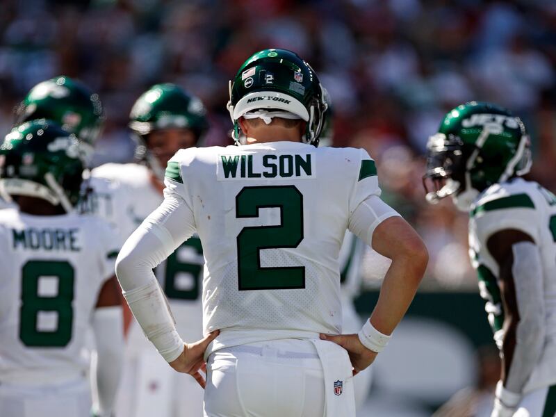 New York Jets quarterback Zach Wilson walks to the huddle against the New England Patriots Sunday, Sept. 19, 2021.