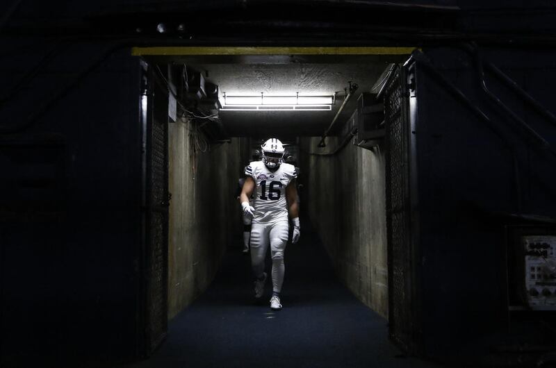 BYU linebacker Harvey Langi walks to the field before the team's Poinsettia Bowl NCAA college football game against Wyoming on Wednesday, Dec. 21, 2016, in San Diego. (AP Photo/Ryan Kang)