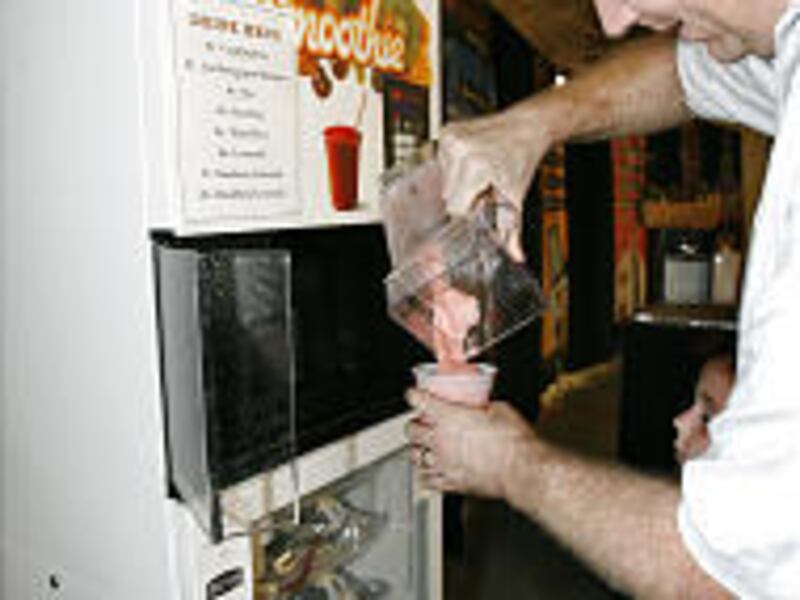 Paul Faerber pours a smoothie from a commercial blender made by Blendtec at an open house. The company was marking the opening of a new building.