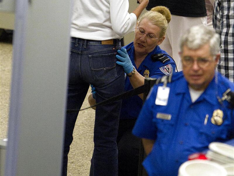 In these photos, female passengers are shown being patted down by a TSA agent as they go through security at Salt Lake City International Airport.