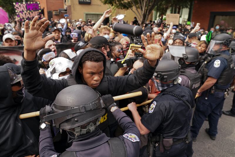 Police and protesters converge during a demonstration, Wednesday, Sept. 23, 2020, in Louisville, Ky. A grand jury has indicted one officer on criminal charges six months after Breonna Taylor was fatally shot by police in Kentucky. The jury presented its decision against fired officer Brett Hankison Wednesday to a judge in Louisville, where the shooting took place.