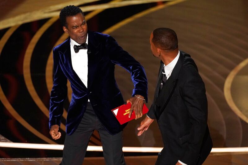 Presenter Chris Rock reacts after being hit on stage by Will Smith.