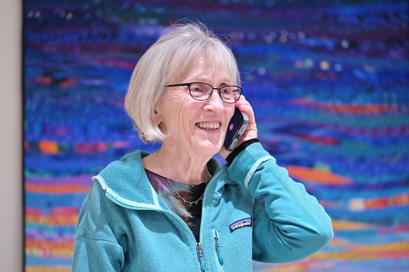 Claudia Goldin speaks to a reporter on the phone in her home in Cambridge, Mass. after learning that she received the Nobel Prize in Economics Oct. 9, 2023.