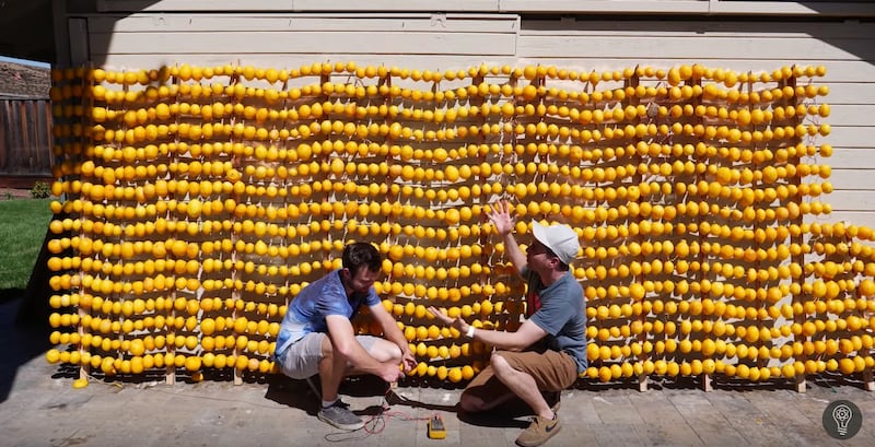 YouTubers Mark Rober (right) and William Osman put the finishing touches on the world's largest lemon battery, which Rober used to help power a Volkwagen electric supercar that broke the all-time record at the Pikes Peak Hill Climb earlier this week.