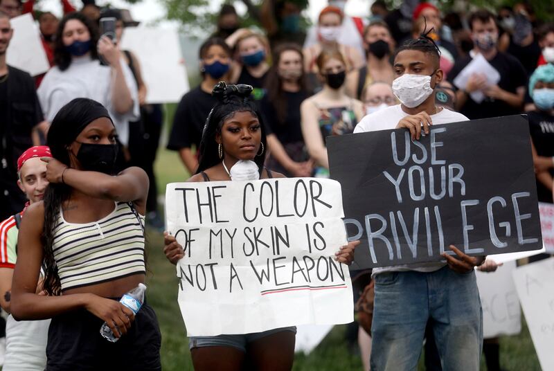 Daisy Mulamba, Daniella Mulamba and Jose Solano gather to protest racism and police brutality in front of the Capitol in Salt Lake City.